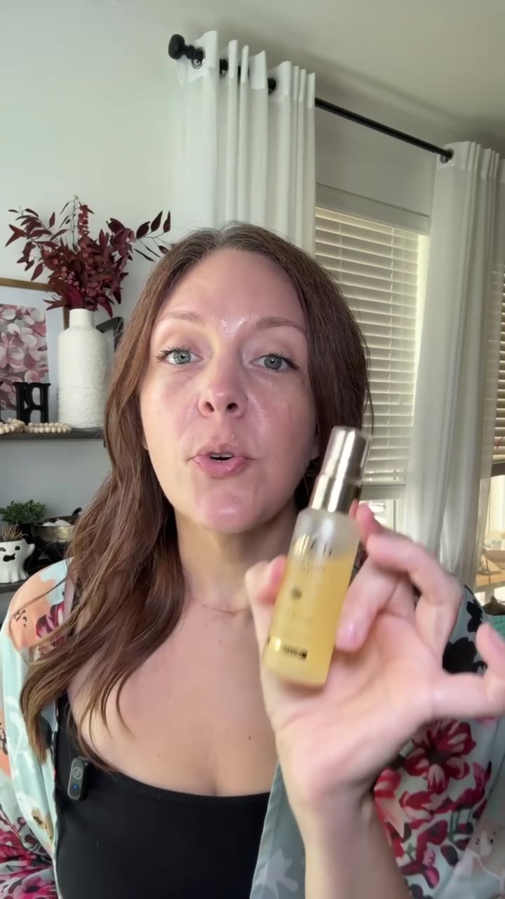 Holding a D'alba white truffle serum bottle up to camera in a living room.